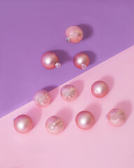 Shiny pastel pink Christmas balls on lilac and pink background. Minimal creative concept for abstract Christmas tree banner or card. Surreal design for season greetings advertisement or editorial.