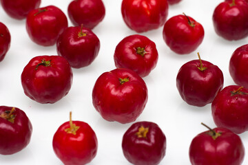 several acerolas on a white background