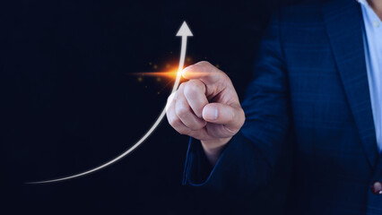 Businessman pointing touching growth on up arrow chart icon, hands touch the up arrow that represents profit rises, monetary growth