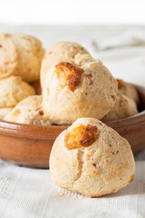 Fototapeta premium Close up of a chipa, typical Paraguayan cheese bread on white table cloth.