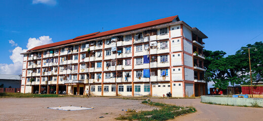 Flat housing buildings that are not maintained and have a large yard for playing. Baubau City, Indonesia