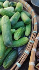 Group of cucumber or Cucumis sativus
on the bamboo round basket at the traditional market.