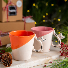 colorful ceramic coffee cups with gift boxes and christmas decoration