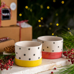 colorful ceramic coffee cups with gift boxes and christmas decoration