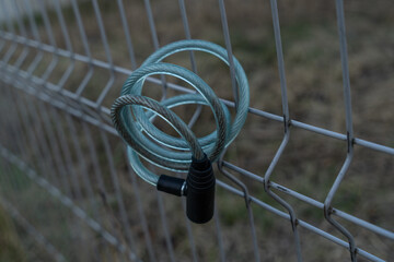 bicycle lock on metal fence close-up