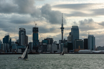 Obraz premium 2020, JANUARY 04 - AUCKLAND, NEW ZEALAND - Famous skyline of Auckland Central Business District during sunset, people anjoying the warm summer evening on their sailboats
