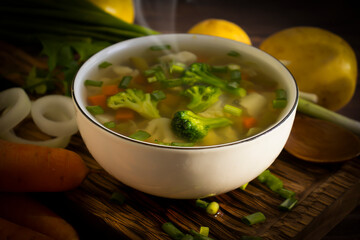 Vegetable soup with broccoli on old background