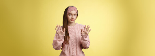 No thanks. Cute unamused picky young girl in knitted sweater, headband showing hold on, slow down,...