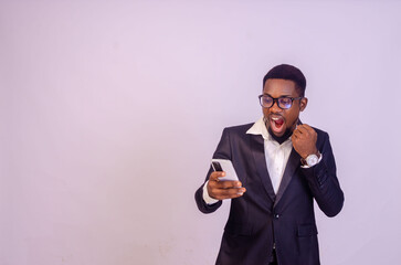 excited young black business man using his phone