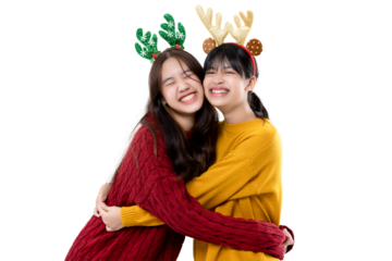 Happy cute Asian girls wear warm knitted sweater hugging together. Christmas celebration concept isolated on transparent background, PNG file format.