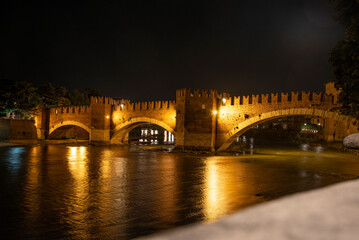 Fototapeta na wymiar VERONA, ITALY - OCTOBER 16, 2021 - Castlevecchio Bridge over the Adige River in Verona at Night