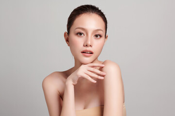 Beautiful young asian woman with clean fresh skin on grey background, Face care, Facial treatment, Cosmetology, beauty and spa, Asian women portrait.