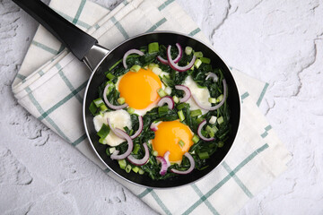 Tasty green Shakshouka served on white textured table, top view