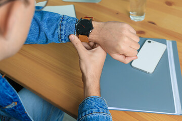 Man checking time in room, closeup. Being late