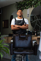 Latin American barber in his own business. Young entrepreneur at his work. Happy Colombian stylist...