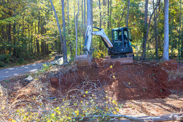 Uprooting trees and preparing land for construction is done with tractor