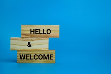 wooden board with the words hello and welcome. Hello and welcome symbol. Business hello and welcome...