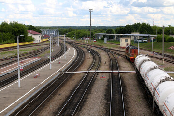 Fototapeta na wymiar Railway tracks, railway station, platform and train with wagons.