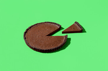 Chocolate pie isolated on a green background. Sliced chocolate cake