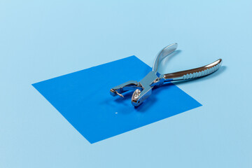 Dental hole punch on a rubber dam.