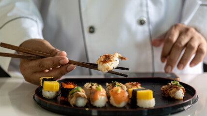 Chef cooking sushi in the kitchen