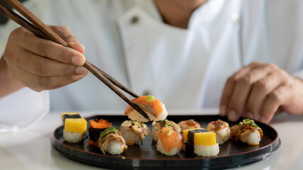 Obraz na płótnie Canvas Chef cooking sushi in the kitchen