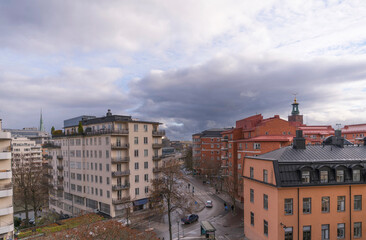 View from the cliff Kungsklippan, down town apartment houses and offices a winter day with dark clouds and low sun in Stockholm