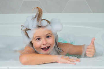 Children bathing. Kid bathes in a bath with foam.