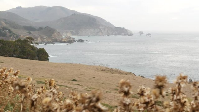 Bixby creek bridge, rocky craggy ocean, cliff or steep bluff, foggy misty weather. Sea water waves on beach. California landscape, Big Sur nature, USA. Pacific coast highway 1, cabrillo scenic road.