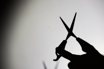 shadow of a man with scissors