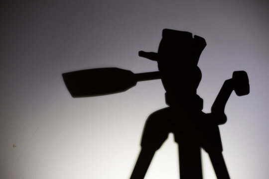 shadow of a man with film tripod