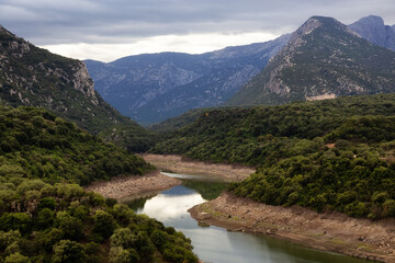 Fototapeta na wymiar River and Mountain Landscape Nature Background. Sardinia, Italy.