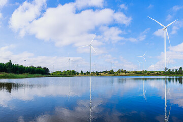 Powerful Wind turbine farm for pure energy production on Beautiful clear blue sky with white clouds...