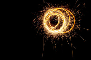Circles with sparks on a black background. Festive sparklers, New Year's abstract lights