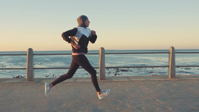 Exercise, fitness and woman running by ocean for body wellness, cardio and workout in the morning. Sports, nature and female athlete run by seaside for marathon training, active and healthy lifestyle