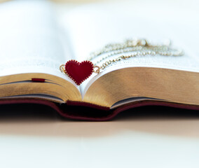 heart shape necklace on a bible page