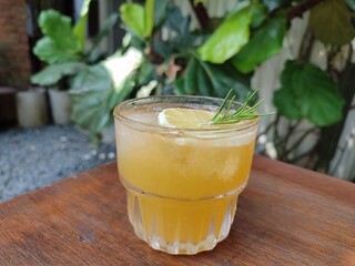 Cold fresh orange juice on the wooden table