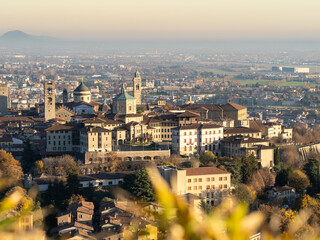 Fototapeta premium Bergamo. One of the beautiful city in Italy. Landscape at the old town from the hill during sunset. Amazing view of the towers, bell towers and main churches. Touristic destination. Best of Italy