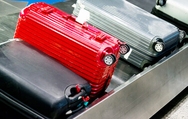 Group of suitcases on conveyor belt of airport
