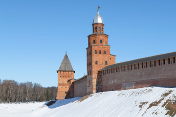 Fototapeta na wymiar Kokuy and Pokrovskaya towers on a sunny March day. Kremlin of Veliky Novgorod. Russia