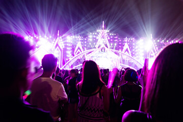 Fototapeta na wymiar Silhouette raising glow stick in the music festival