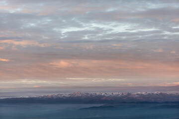 sunset at the top of the mountain with views of the clouds and the forest with a spectacular colors of sunlight
