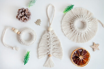 Christmas tree toys made of natural materials, cotton thread. Top view. New Year's layout of macrame products for Christmas, pendants on a white background. Eco decorations, ornaments, hand made
