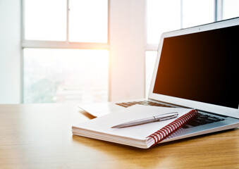 Office desk with laptop and notebook