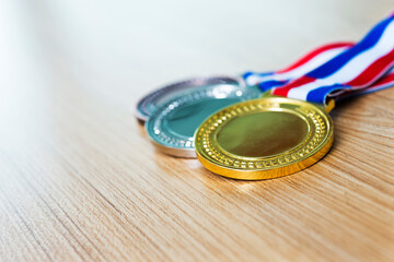 Set of gold silver and bronze award medals  on wooden table