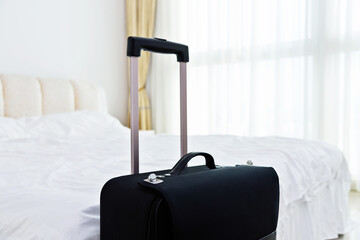 Black luggage in hotel room