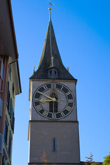 Church tower with largest church clock face in Europe of medieval church St. Peter at the old town of Zürich on a sunny late summer day. Photo taken September 22nd, 2022, Zurich, Switzerland.