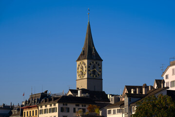 Church tower with largest church clock face in Europe of medieval church St. Peter at the old town of Zürich on a sunny late summer day. Photo taken September 22nd, 2022, Zurich, Switzerland.