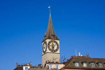 Church tower with largest church clock face in Europe of medieval church St. Peter at the old town of Zürich on a sunny late summer day. Photo taken September 22nd, 2022, Zurich, Switzerland.