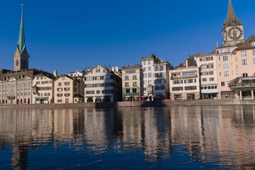 Beautiful cityscape of the old town of Zürich with Limmat River in the foreground with historic houses and bridge on a sunny late summer morning. Photo taken September 22nd, 2022, Zurich, Switzerland.